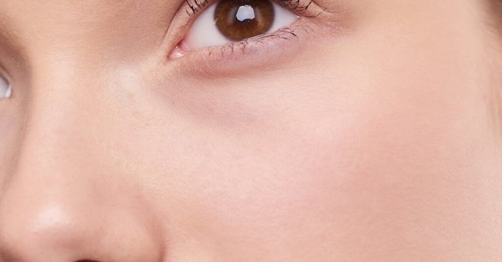 Close-up portrait capturing the natural beauty and smooth skin of a young woman.